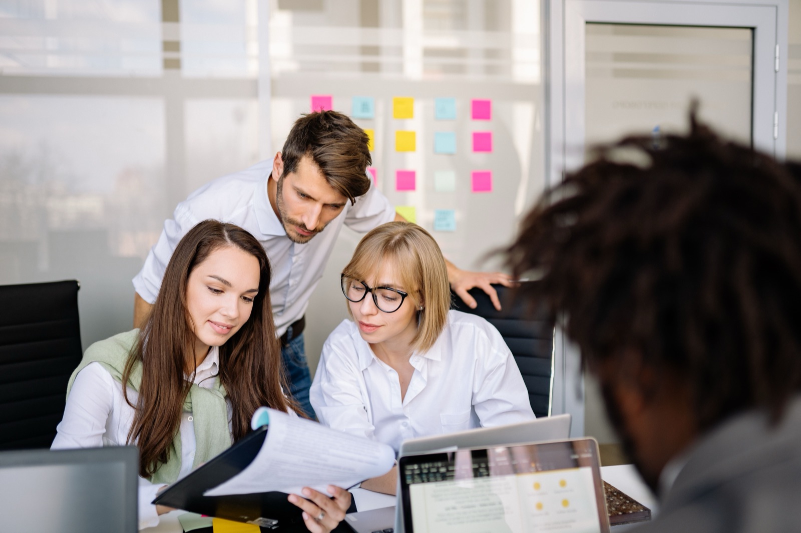 A team collaborating and reviewing documents together in an office